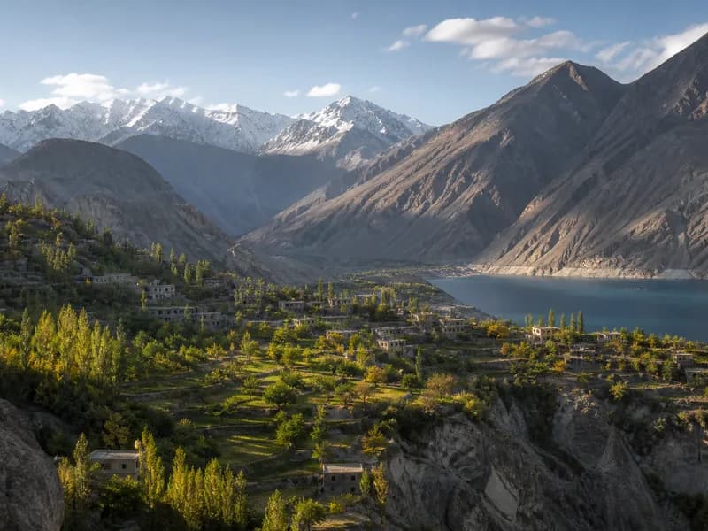 Art-directed view of terraced villages, a mountain lake and Karakoram peaks representing the Hunza and Gilgit-Baltistan journey